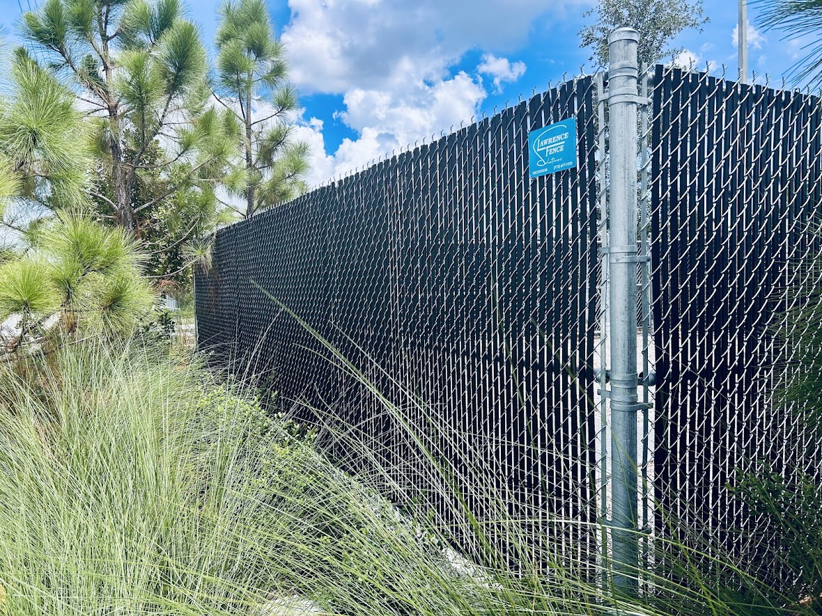 Black privacy-slatted chain-link commercial perimeter
