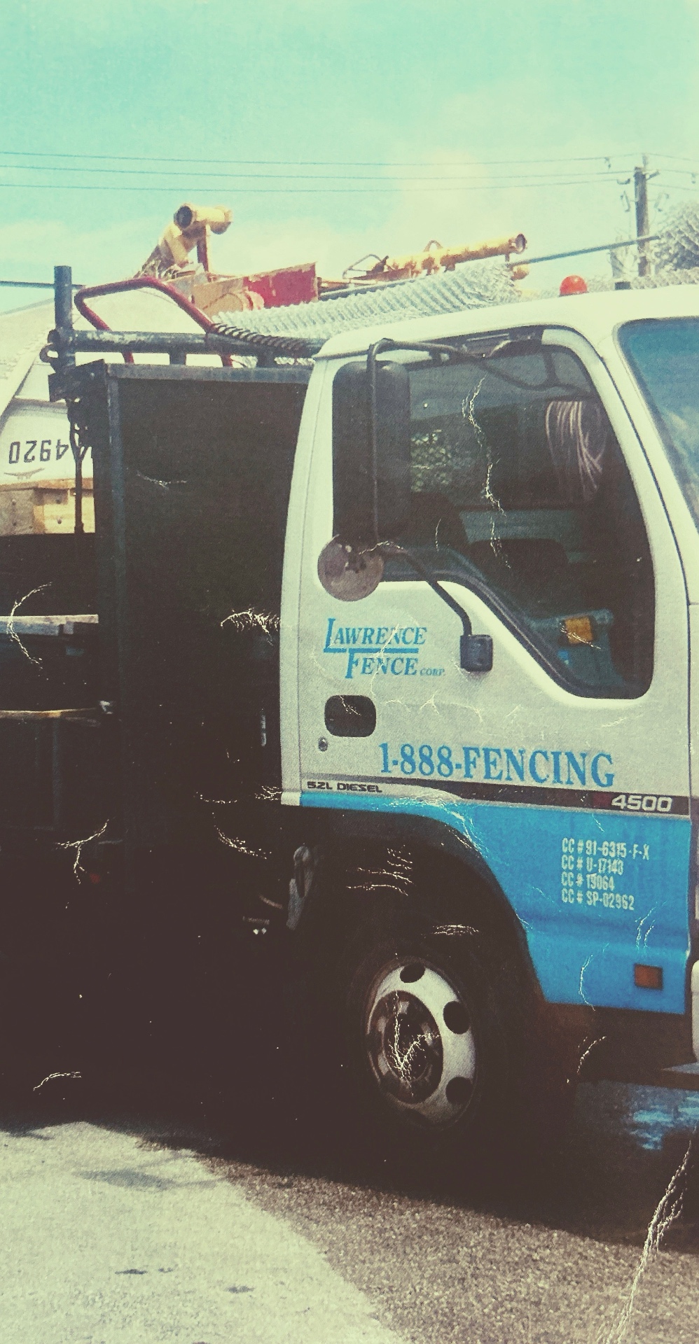 Vintage photo of the original Lawrence Fence Corp blue & white truck