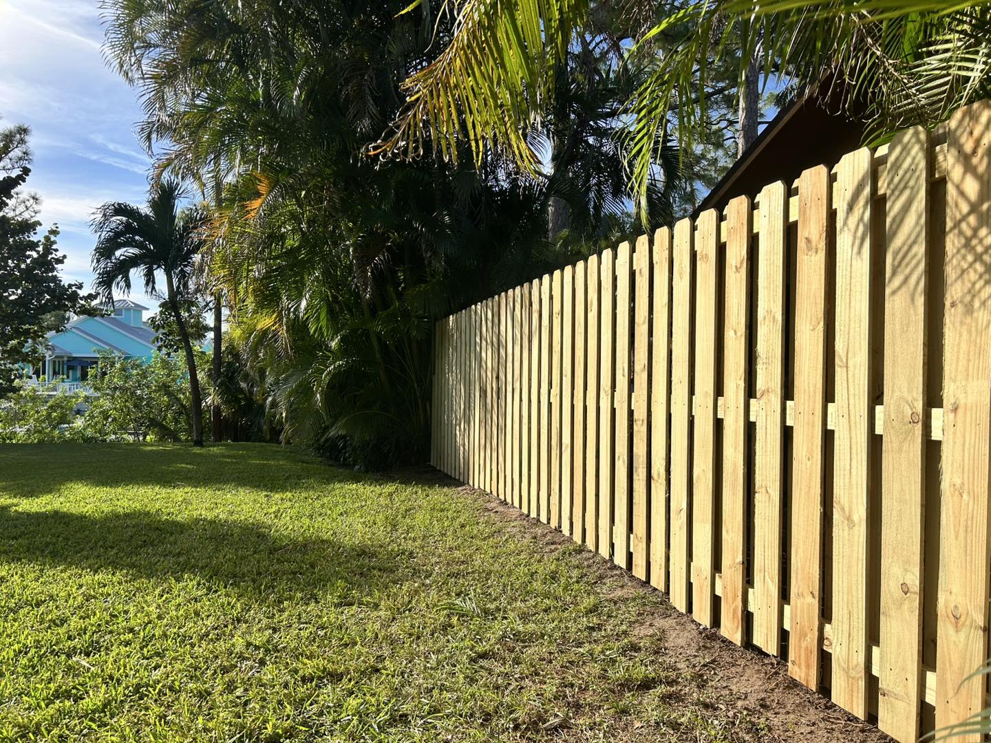 Shadowbox wood privacy fence framing a Stuart, FL backyard