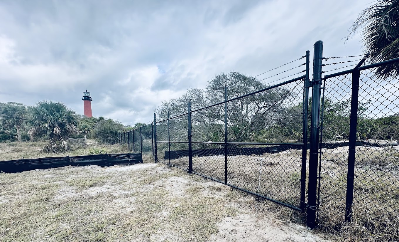 Black chain-link commercial gate near Jupiter Lighthouse on the Treasure Coast