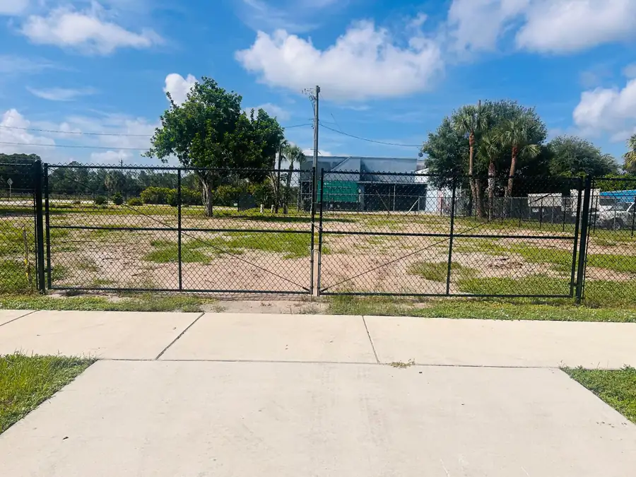 Black temporary fence double drive gate installed at a purchased fence perimeter