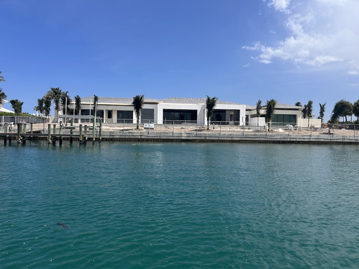 Chain-link construction perimeter fence around a waterfront Florida estate